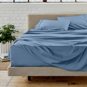 Microfiber sheet set on a bed with a white brick wall in the background