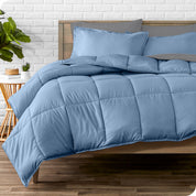 A wooden bed frame with sheets, pillow shams and a comforter on the bed