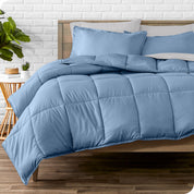 A wooden bed frame with sheets, pillow shams and a comforter on the bed