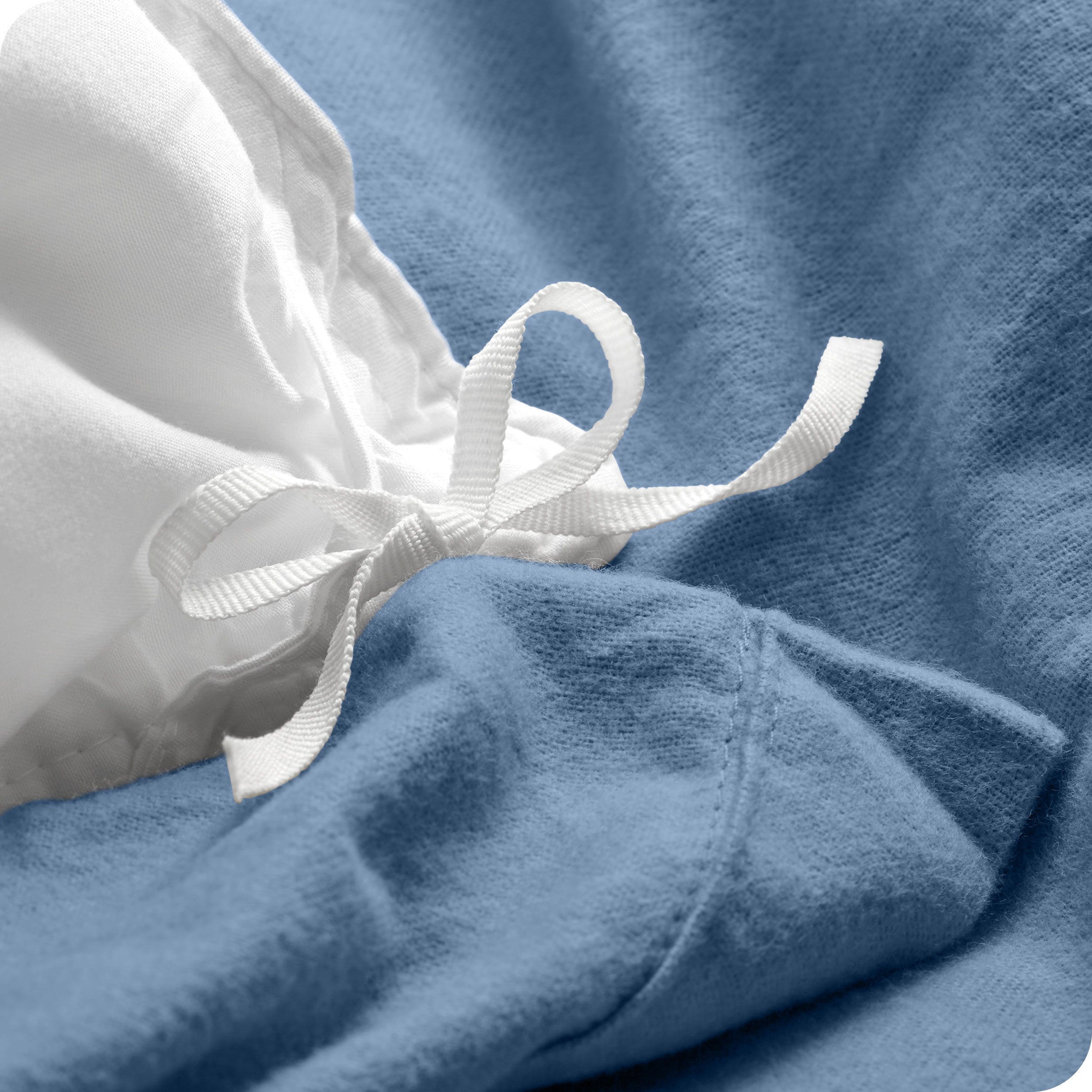 A folded stack of a flannel duvet cover with two pillows on top.