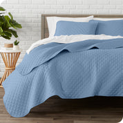 A quilted coverlet set on a bed