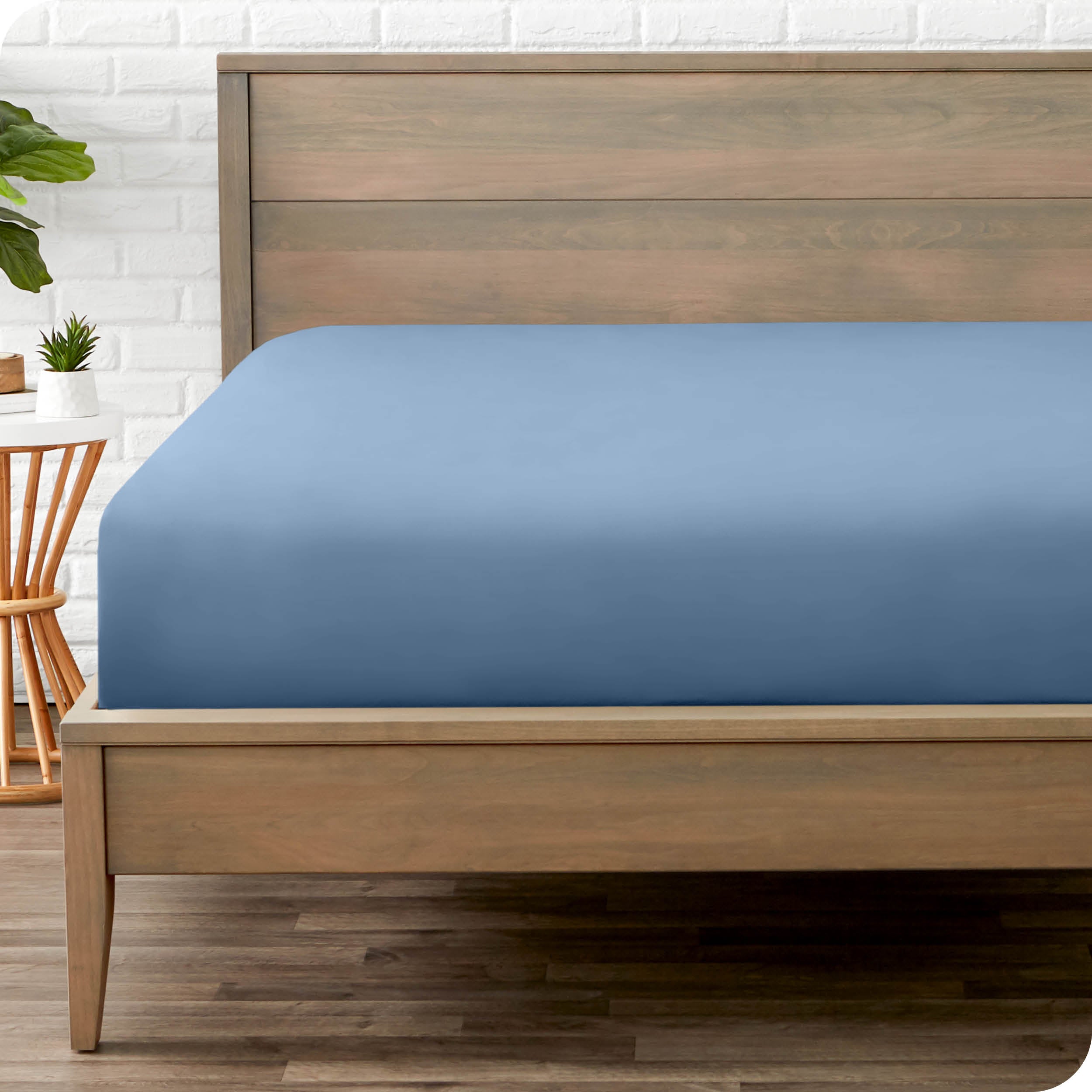 End of bed view with fitted sheet made on the mattress of a modern bed. 