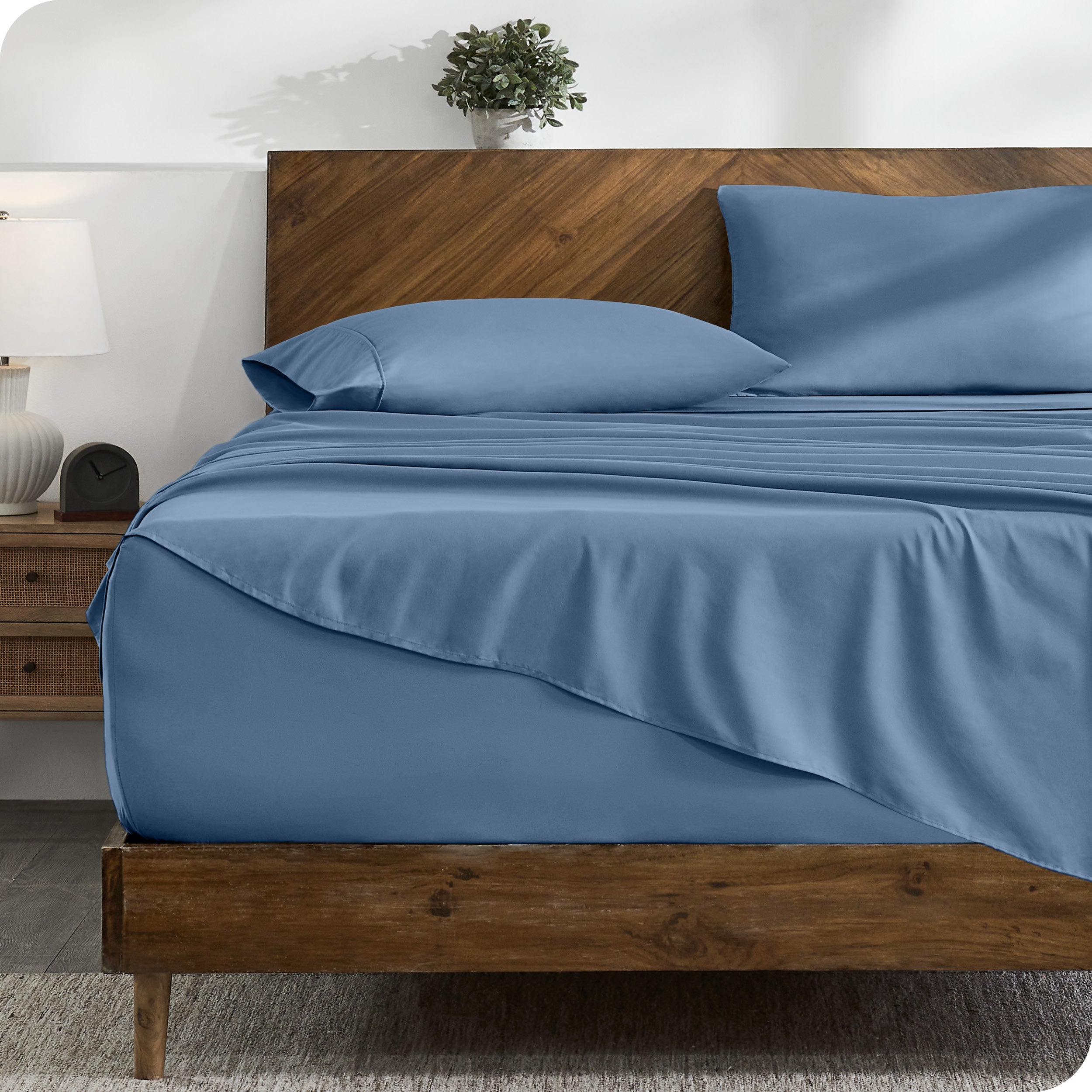 A cozy bedroom with a bed covered in soft microfiber sheets


