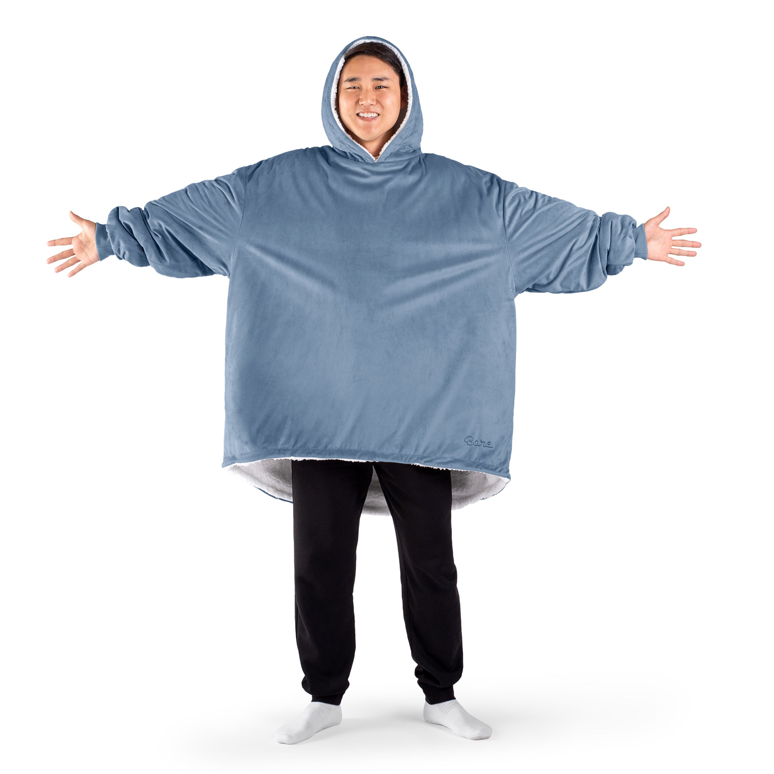 An adult with a sherpa wearable blanket on