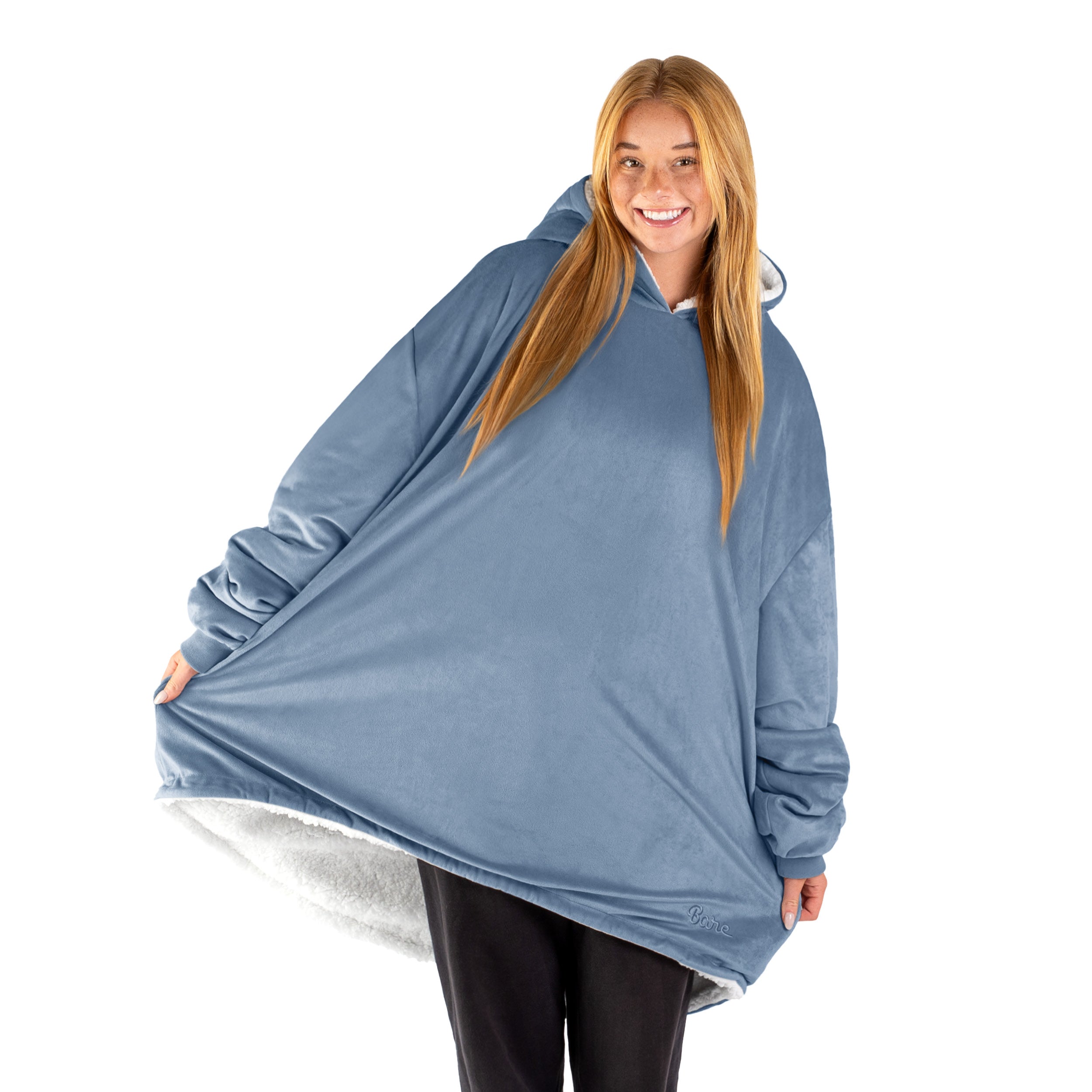 An adult with a sherpa wearable blanket on
