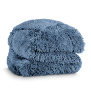 A shaggy faux fur blanket folded