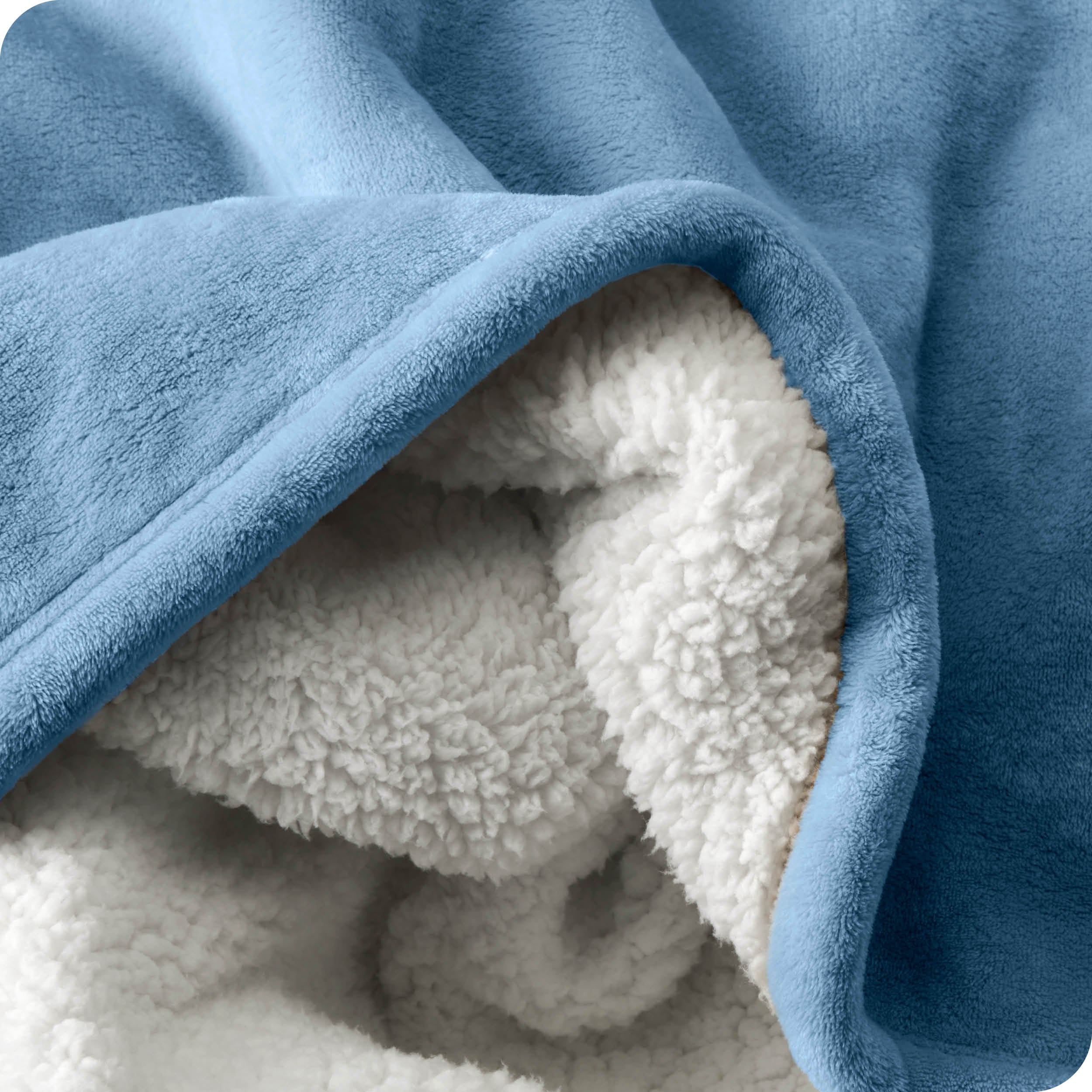 Close up of sherpa blanket showing texture of velvety soft side and sherpa backing