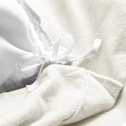 A folded stack of a flannel duvet cover with two pillows on top.