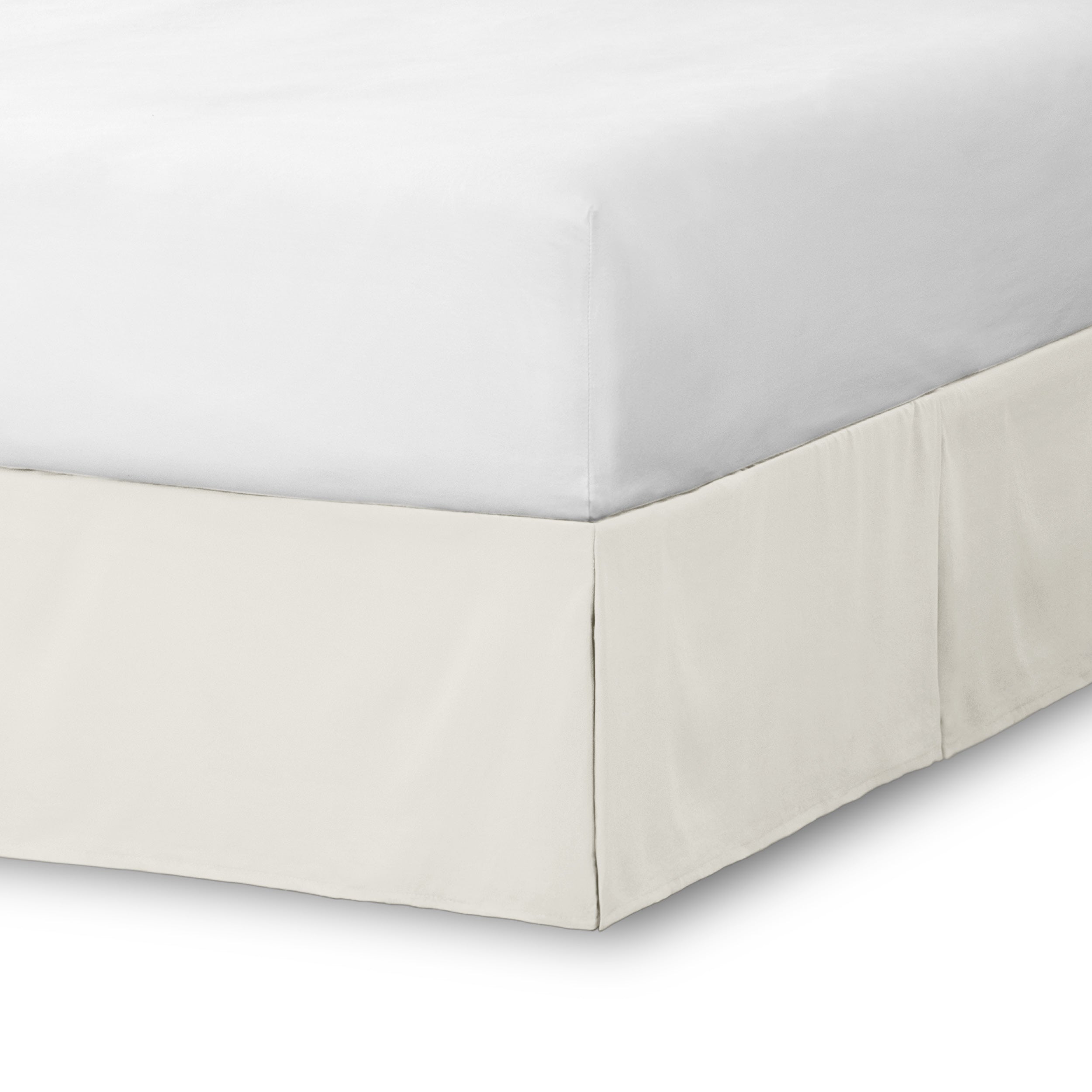 The corner of a bed skirt on a bed frame