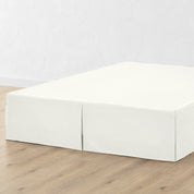 A bed skirt draped over a box spring