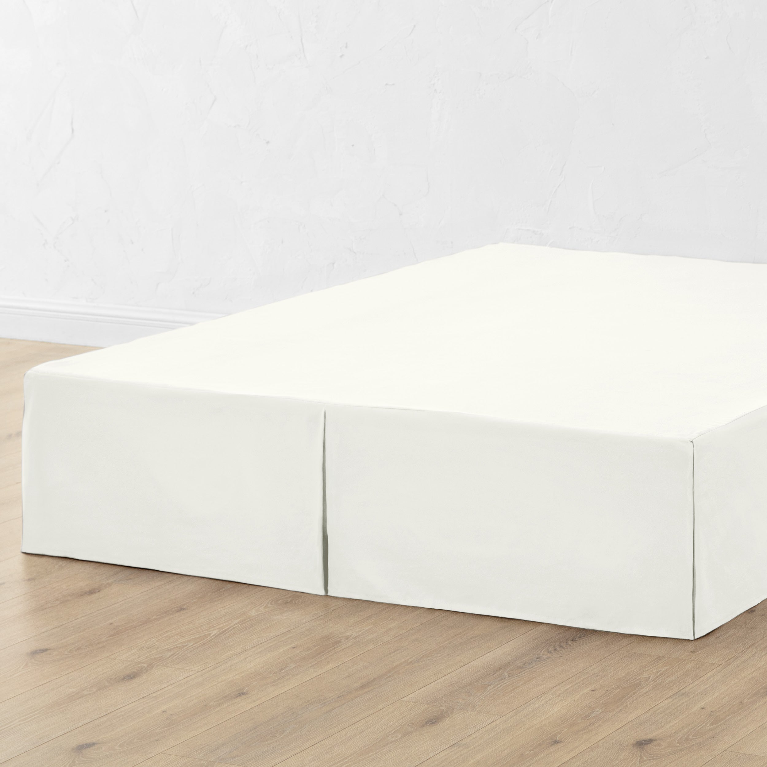 A bed skirt draped over a box spring