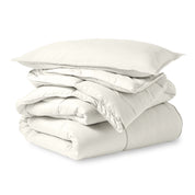 A microfiber comforter folded neatly with a pillow from above
