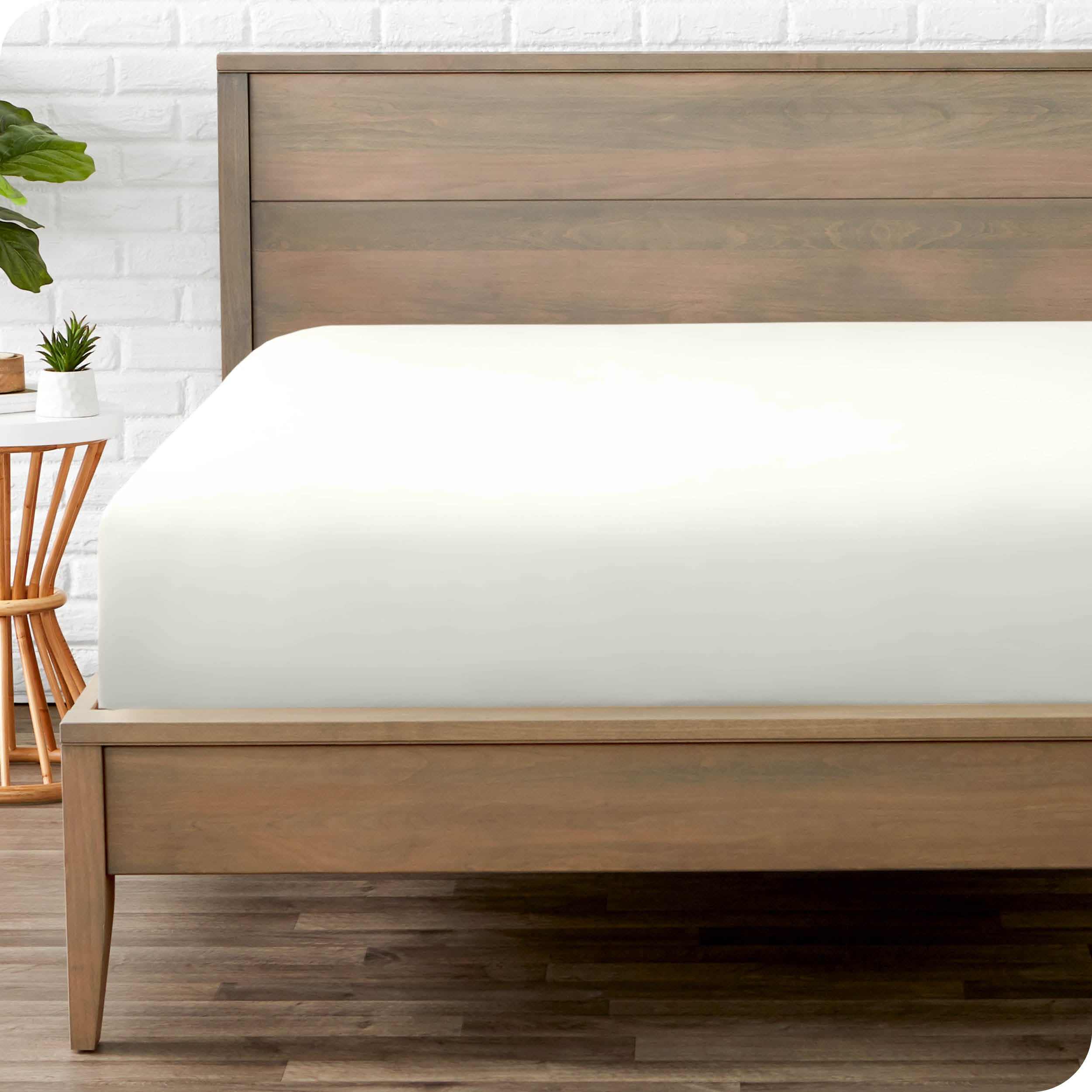 End of bed view with fitted sheet made on the mattress of a modern bed. 