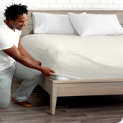 A man putting the microfiber fitted sheet on a mattress. 
