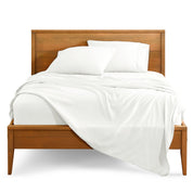 Microfiber sheet set on a bed with a wooden bed frame