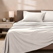 View of fleece sheets from the end of a bed with the top sheet draped over the side and end