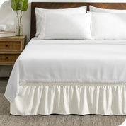 A wrap around bed skirt on a bed