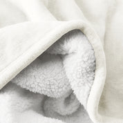 Close up of sherpa blanket showing texture of velvety soft side and sherpa backing