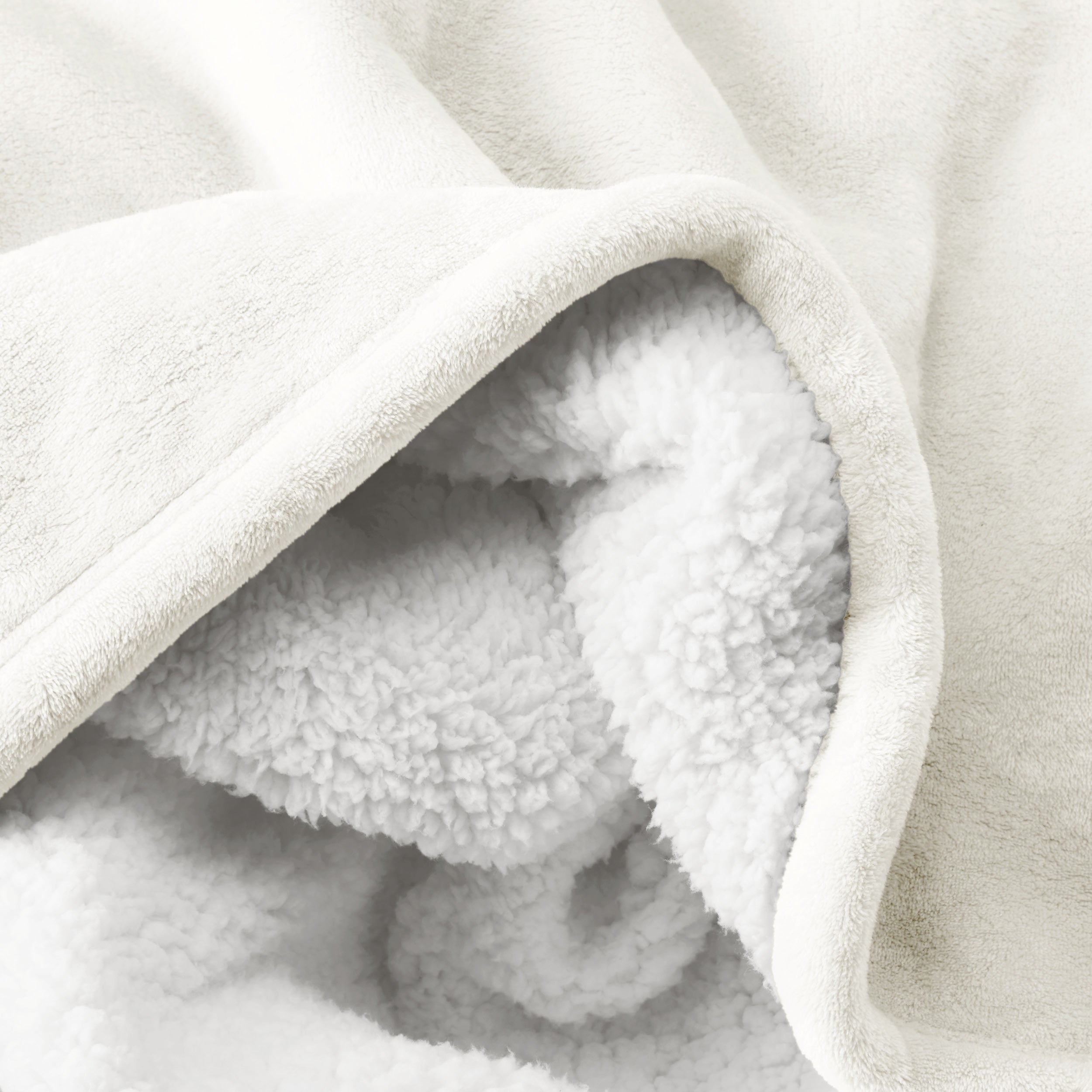 Close up of sherpa blanket showing texture of velvety soft side and sherpa backing