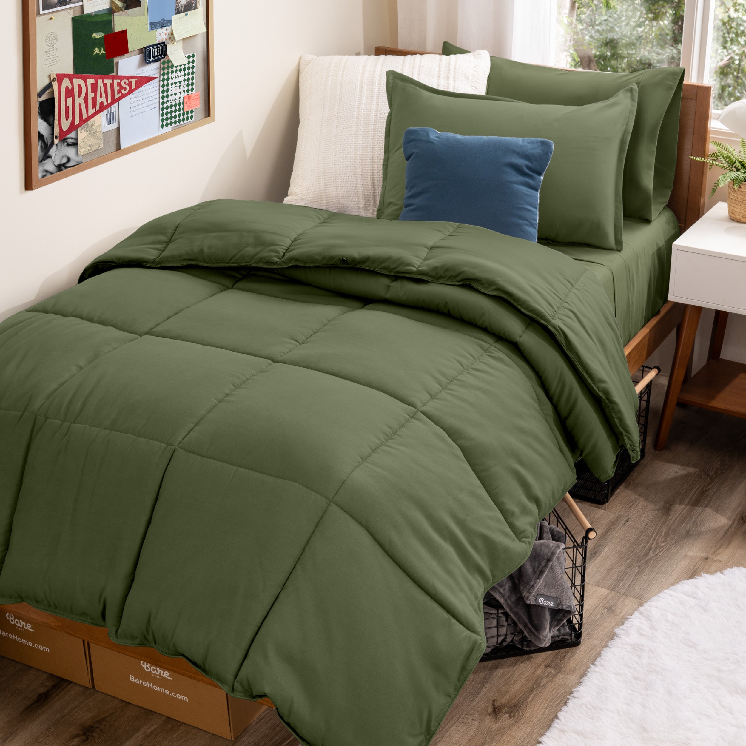 A college dorm room with a bed in a bag set on the mattress