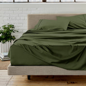 Microfiber sheet set on a bed with a white brick wall in the background