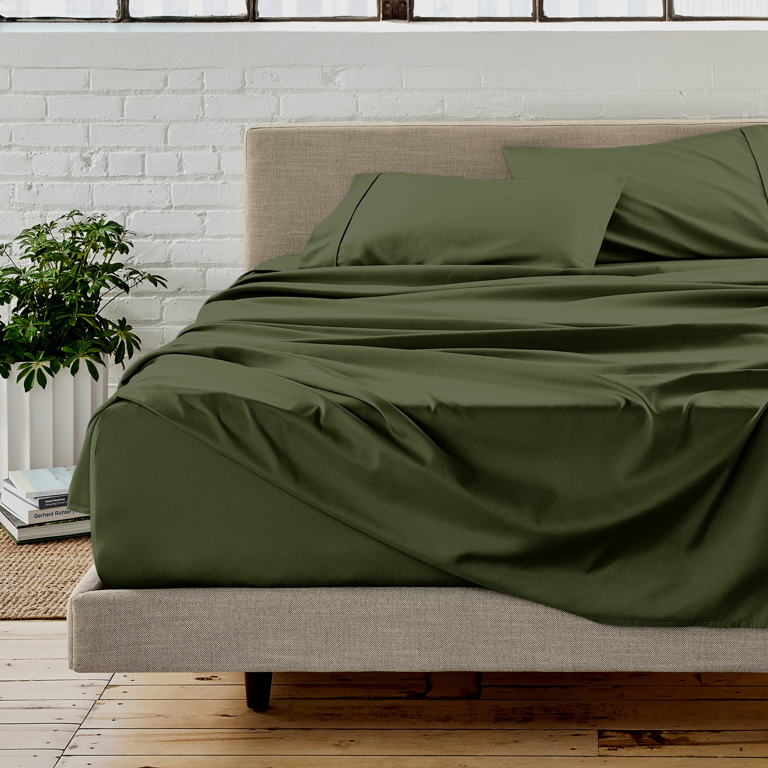 Microfiber sheet set on a bed with a white brick wall in the background