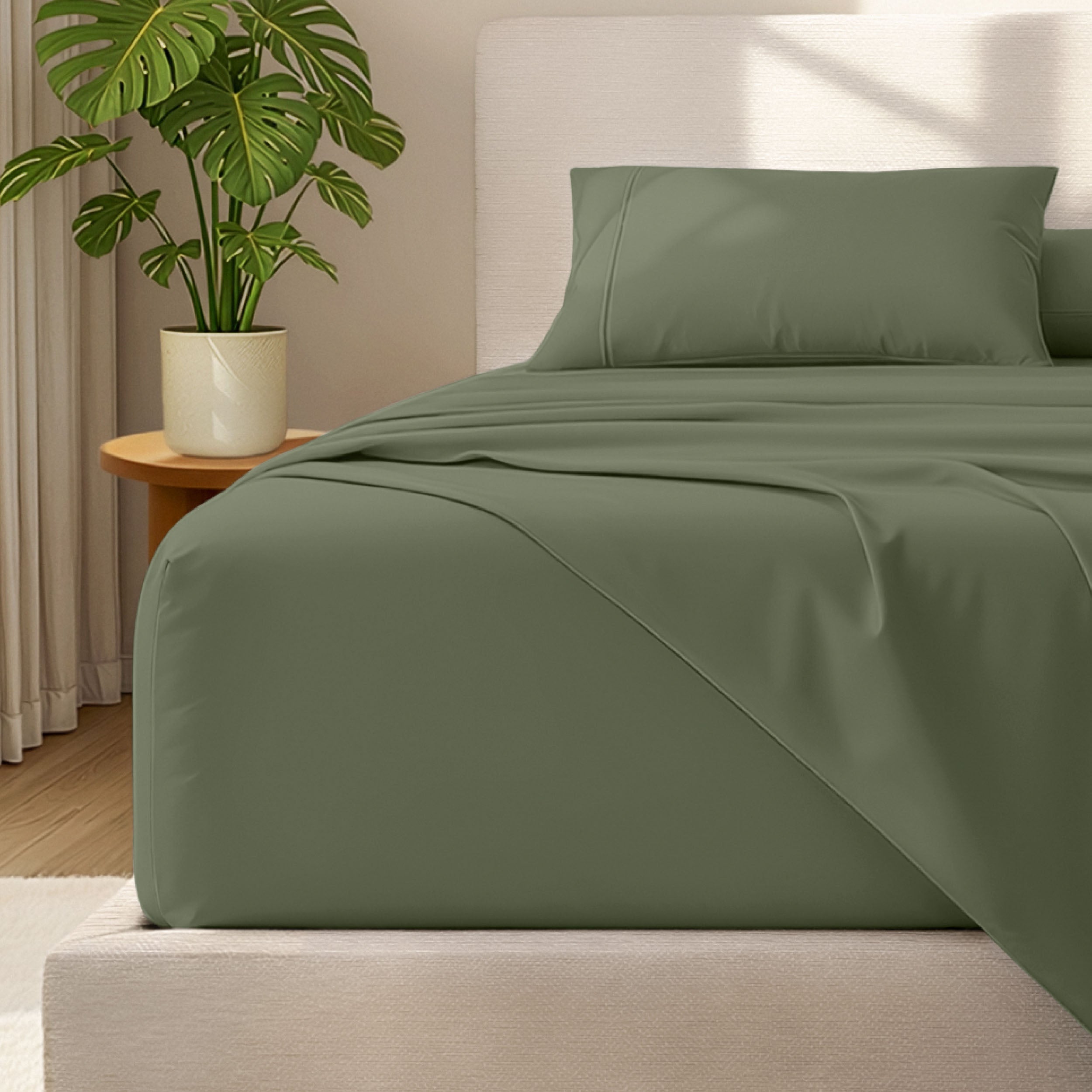 Microfiber bed sheets and pillowcases on a bed with a plant in the background