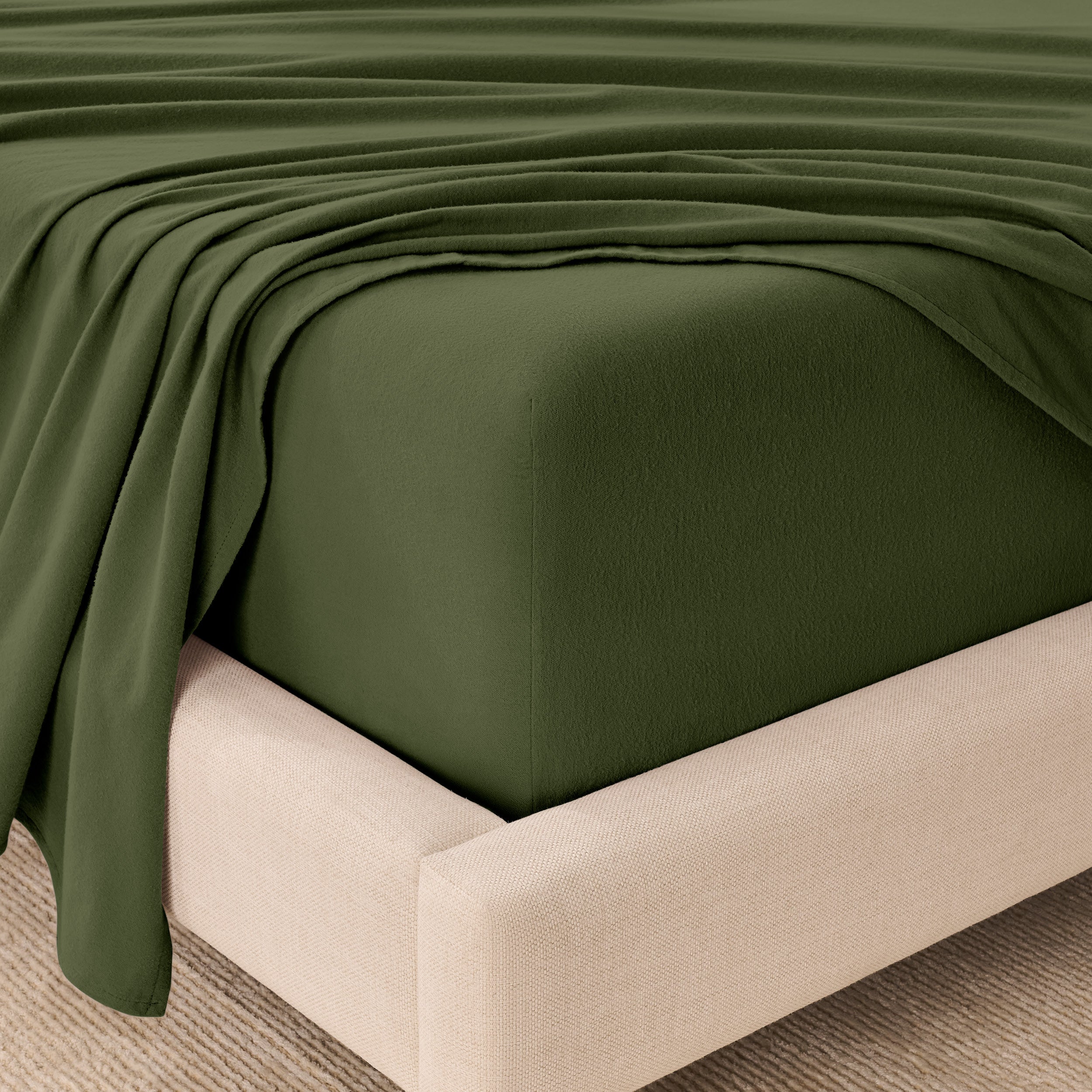 Organic flannel sheets on a beige bed frame
