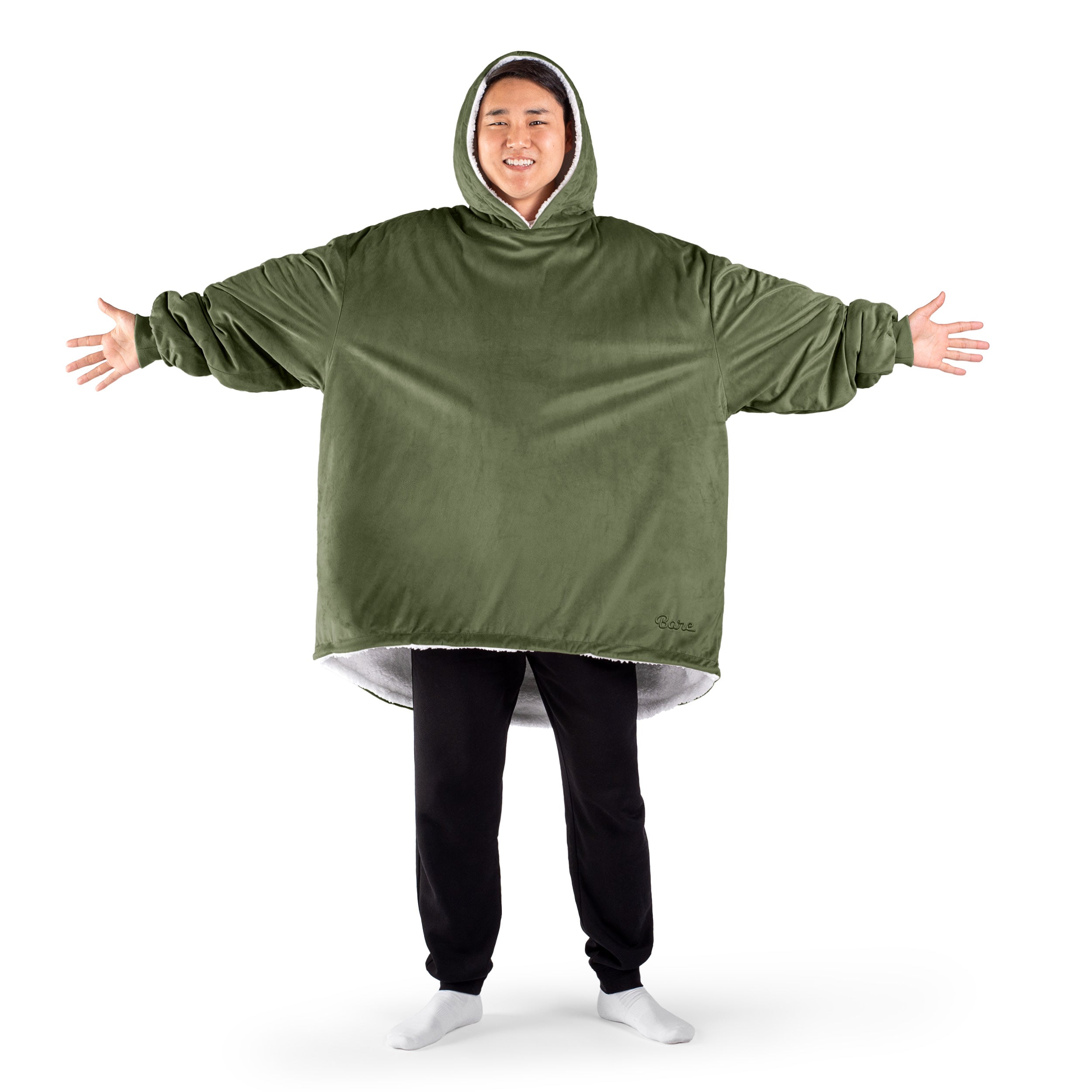 An adult with a sherpa wearable blanket on