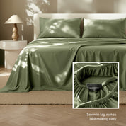 Tencel bed sheets on a bed with a lamp and side table in the background.