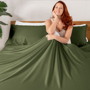 A smiling woman sitting on a bed