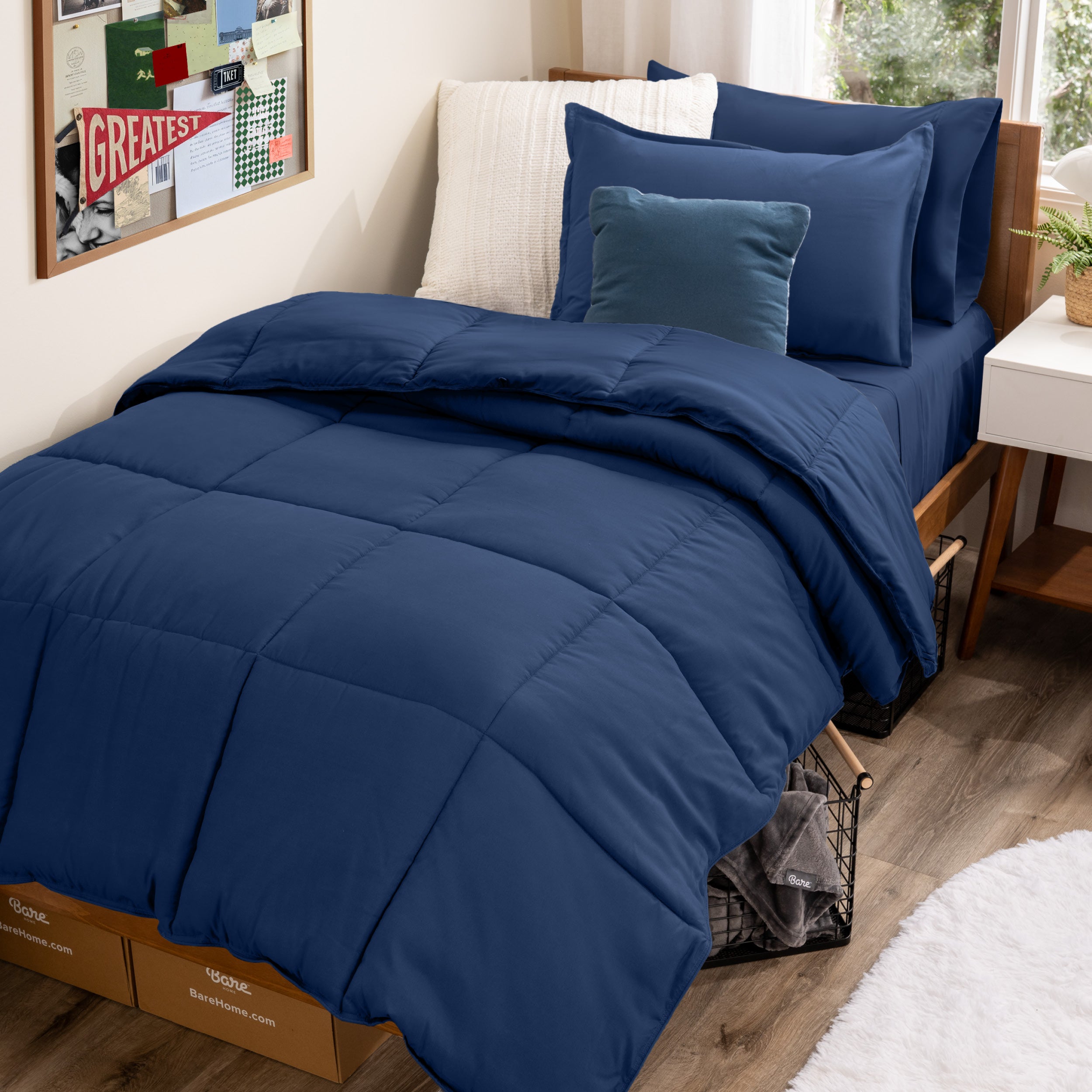 A college dorm room with a bed in a bag set on the mattress