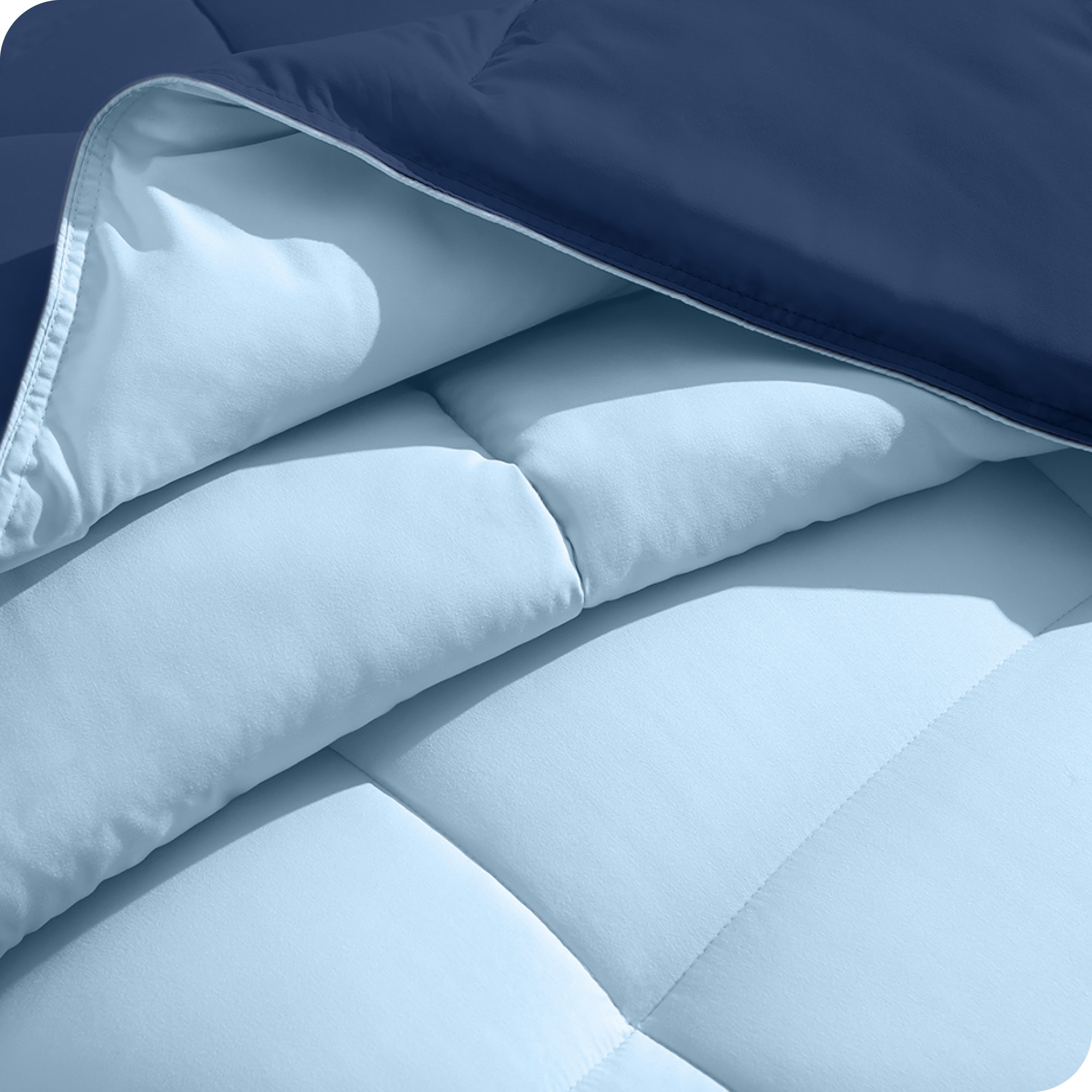 Close up of the comforter folded back showing the two different colored sides.