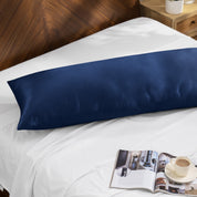 Bamboo body pillow on a bed with a magazine and cup of coffee nearby.