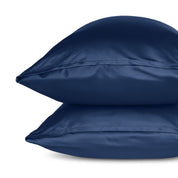 Two pillows with pillowcases stacked on a white background