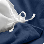 A folded stack of a flannel duvet cover with two pillows on top.