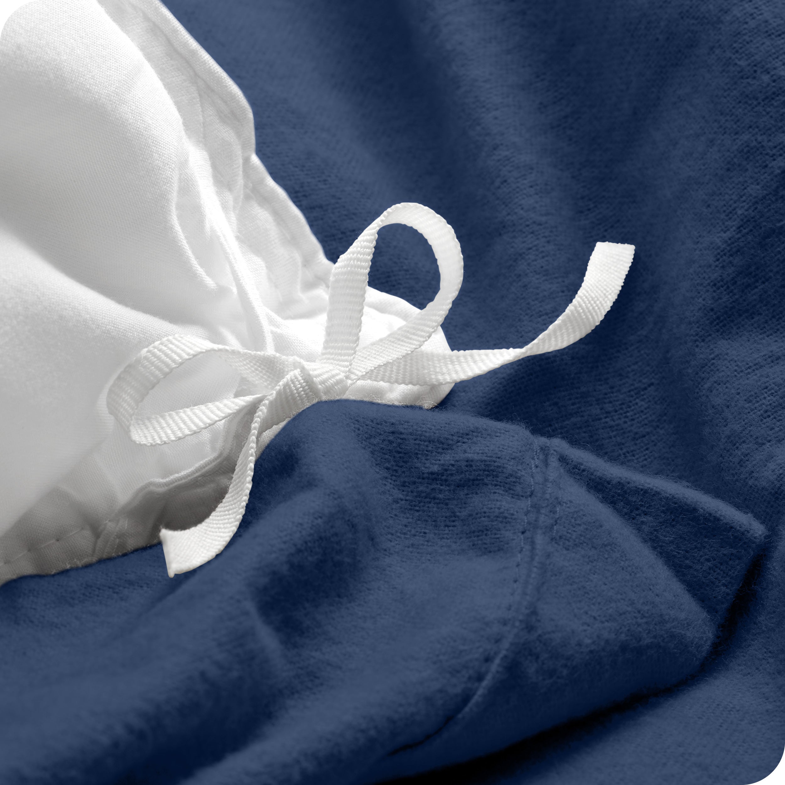 A folded stack of a flannel duvet cover with two pillows on top.