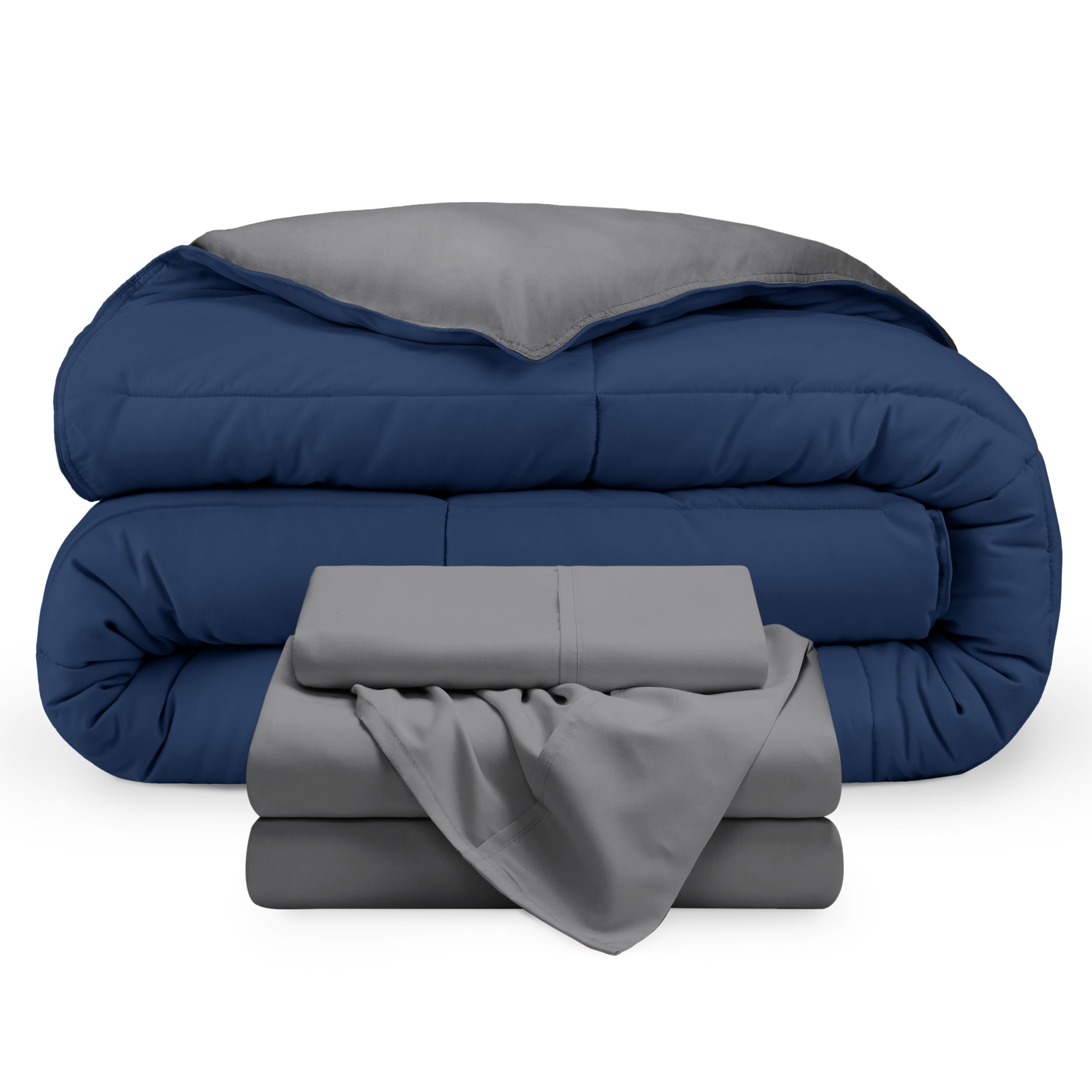 A reversible microfiber comforter and a coordinating sheet set folded and stacked 