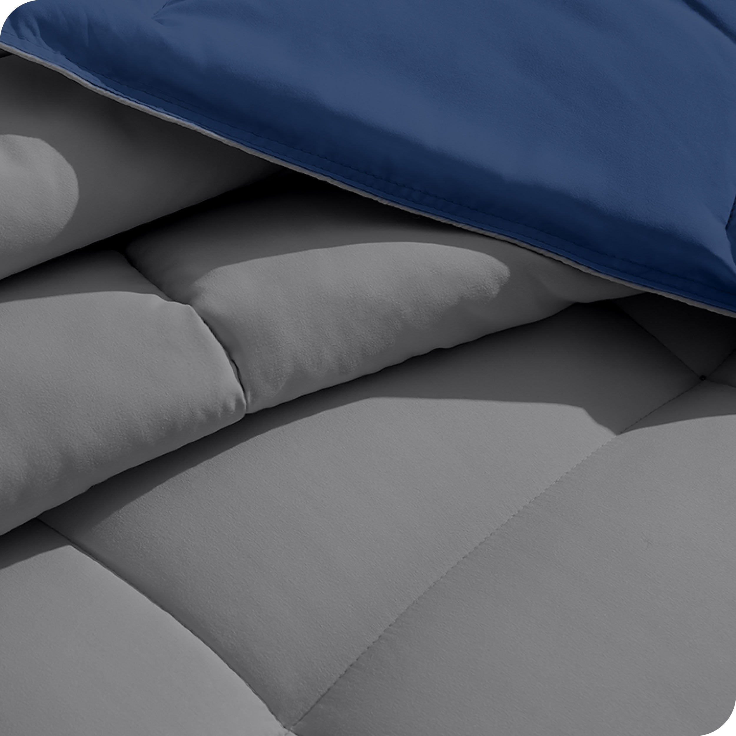 Close up of the reversible comforter showing the box stitching and the two colors