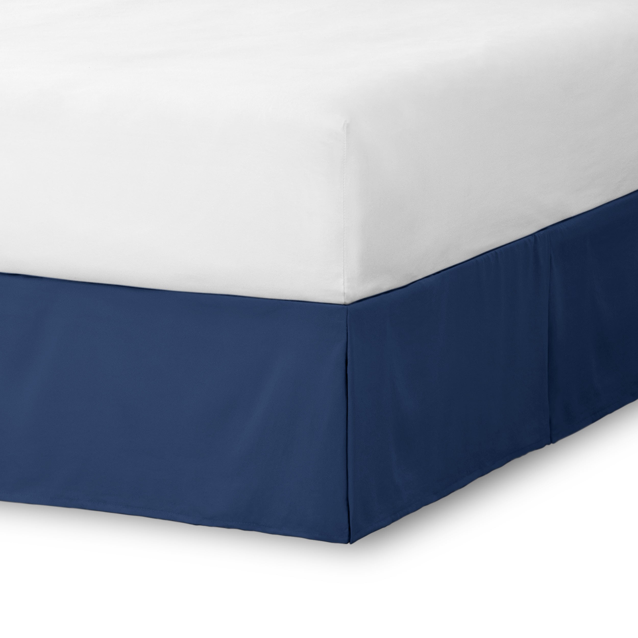The corner of a bed skirt on a bed frame