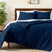 A modern bed with a down alternative comforter set on it
