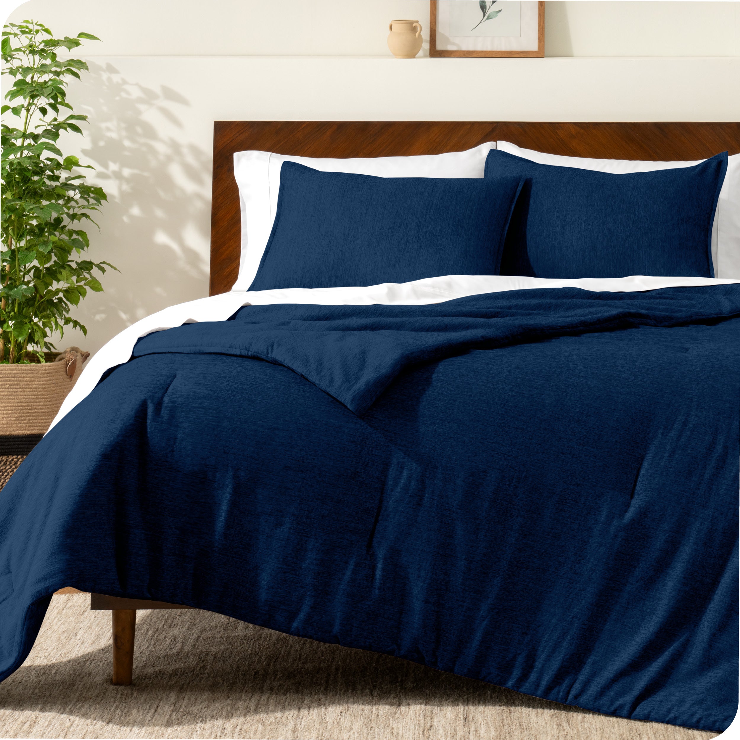 A modern bed with a down alternative comforter set on it
