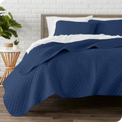 A quilted coverlet set on a bed