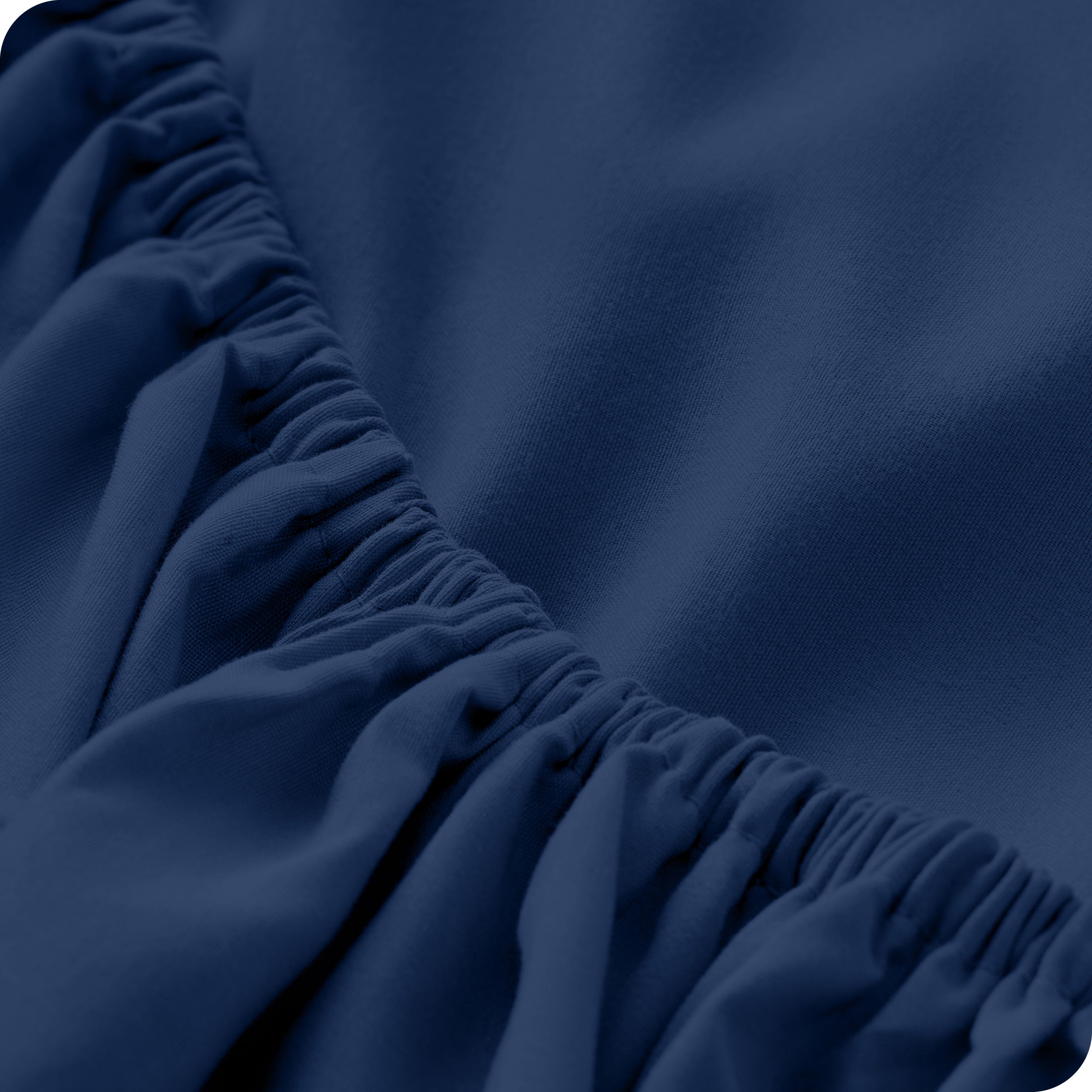 A close up of the elastic of a microfiber fitted sheet. 