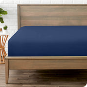 End of bed view with fitted sheet made on the mattress of a modern bed. 