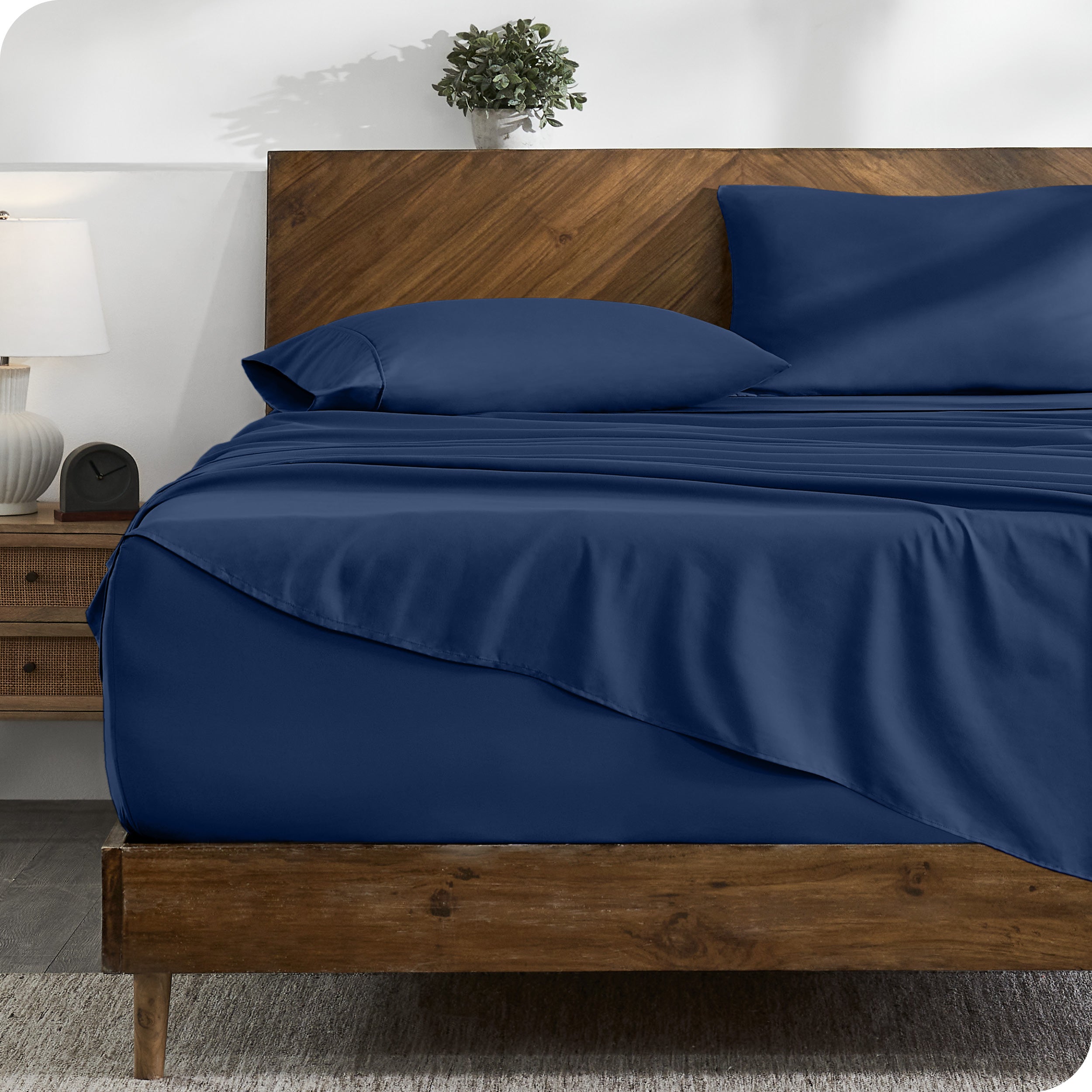 A cozy bedroom with a bed covered in soft microfiber sheets

