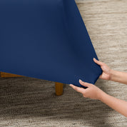 Person putting a stretch fitted sheet on a mattress