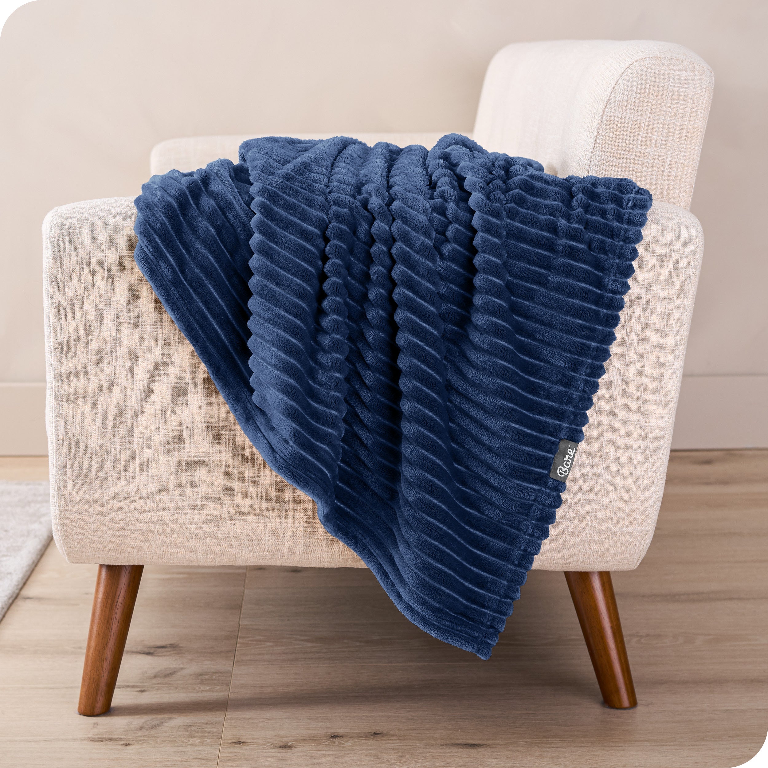 A blanket is draped over the arm of a small chair