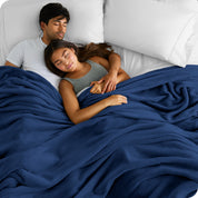 A couple sleeping while covered with a microplush blanket