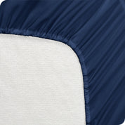 A mattress pad wrapped around the side and back of a mattress